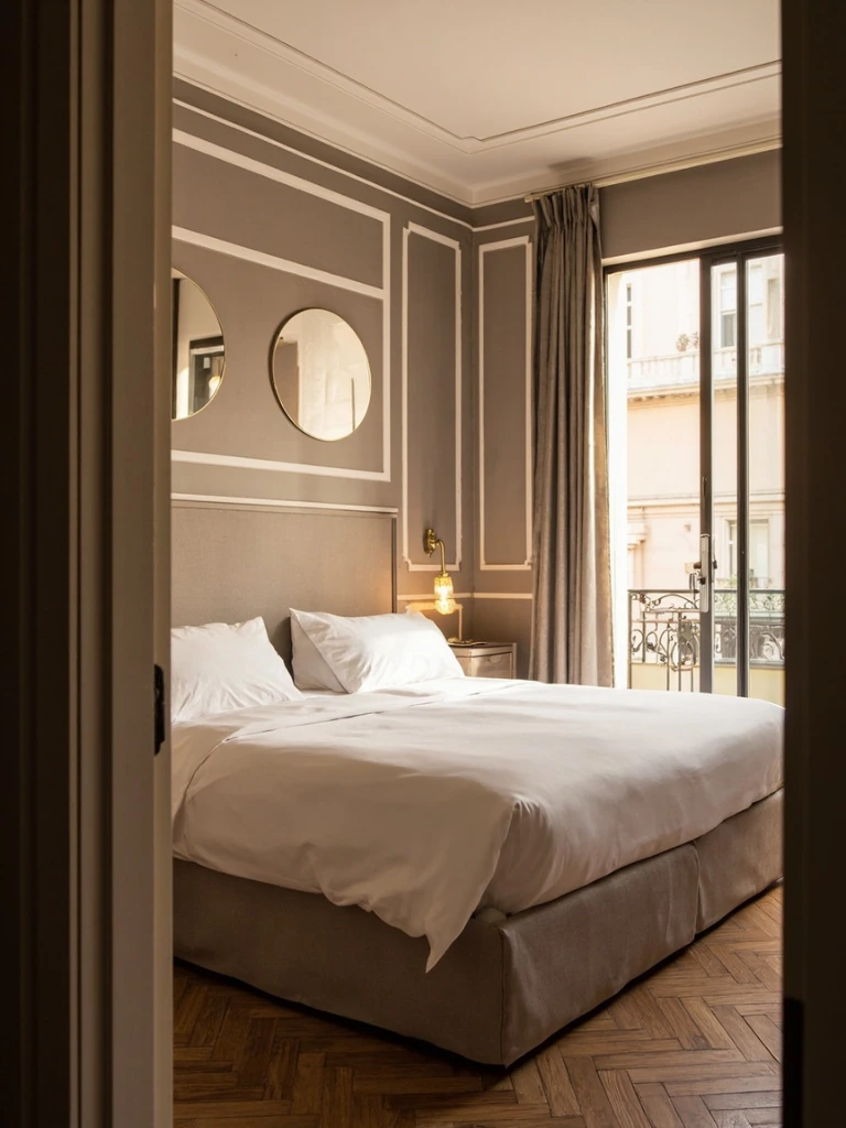 A Deluxe room with herringbone parquet and Murano glass sconces